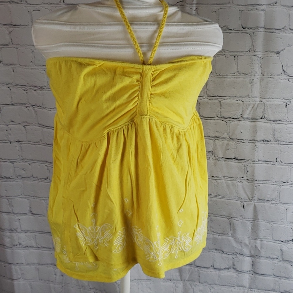 Yellow sleeveless shirt with white embroidery